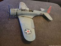Side view of the WWII US Navy model airplane showing wing and fuselage details.