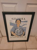 Framed portrait art print of Gloria Anzaldua with the name text on top and bottom of the image.