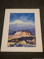 Full view of signed and numbered lithograph print showing landscape of mesas under cloudy sky.