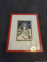 Framed print showing entire picture and mat in red frame.