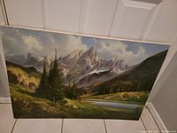 Front view of signed landscape painting with mountain, trees, lake, and small house