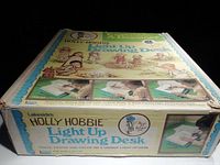 Top side of original Holly Hobbie Light Up Drawing Desk box showing vintage artwork, product title and features.