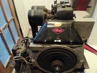 Side view of Petter diesel stationary engine showing black metal housing with see-through wiring and mechanical details.