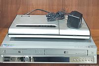 Front view of Insignia DVD-RW player showing dual disc trays and control buttons