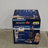 Front view of Bissell Revolution HydroSteam Pet cleaner box showing product image and features
