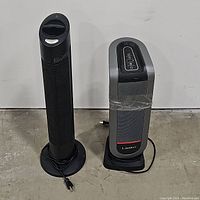 Both Sharper Image Ionic Breeze air purifier and Lasko ceramic tower heater side by side, showing overall size and design