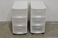 Both white rolling totes side by side, showing front view with all three drawers visible.