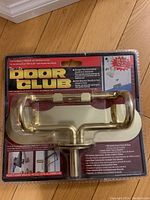 Door Club anti theft door security device in sealed original packaging, showing front side with product and branding.