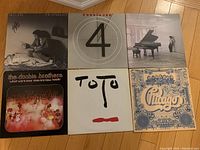 Image showing six vinyl record albums laid out on floor: Billy Joel, Foreigner, UB40, The Doobie Brothers, Toto, and Chicago.