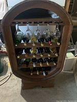 Front view showing wine glasses hanging and bottles stored horizontally in rack