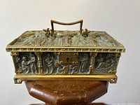 Front view showing relief figures flanking central keyhole plate