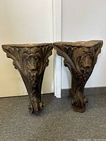Pair of solid carved wood piano legs with detailed grape and leaf carvings showing overall condition and design
