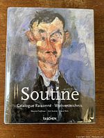 Front cover of the hardcover art book featuring a painted portrait in expressionist style by Chaim Soutine with title text 'Soutine Catalogue Raisonné • Werkverzeichnis' and author names Maurice Tuchman, Esi Dunoyer, Klaus Perls. Publisher is Taschen.