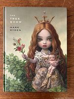 Front cover of 'The Tree Show' by Mark Ryden featuring a surreal portrait of a girl in a crown holding a baby.