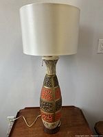 Lamp off showing chalkware base colorful sections and textured details