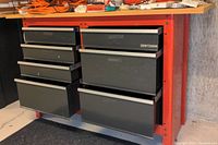 Full front view of red Craftsman base with seven drawers under wooden top