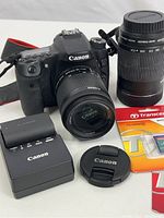 Overview of kit: camera with lens, second lens, charger, lens cap and memory cards