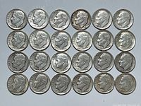 Top view of all 24 Roosevelt dimes arranged in four rows.