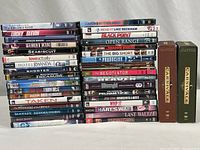 Photo shows stacked DVDs of various movies with two green Carnivale box sets on the right. Titles are clear.