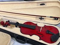 Close-up of violin inside padded case with bow above