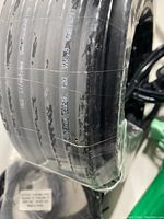 Close-up photo of a coil of black self-regulating heating cable with printed electrical specifications on the insulation.