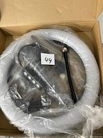 LED ring light inside plastic packaging with flexible arm and buttons visible.