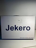 White box with 'Jekero Multimedia Portable Video Player' labeling, showing the brand and packaging.