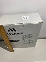 Front and side views of ISERWE jewelry organizer box with ruler to show scale