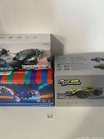 Photo of four boxed kids remote control cars. Left to right visible are Transformers car, RapGo Monster car, iFollower red stunt car, and iFollower blue stunt car boxes stacked.