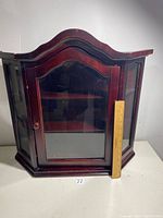 Front and side view of the mahogany curio cabinet with measuring ruler placed beside showing scale.