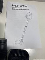 Instruction manual for PrettyCare W400 vacuum cleaner depicting product outline and branding.