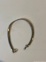 Full view of the sterling silver herringbone bracelet laid flat, showing the entire length and clasp.