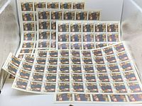 Four sheets of Canadian 8 cent stamps commemorating the 1976 Montreal Olympics displayed overlapping, showing multiple stamps per sheet and the distinct artwork of athletes and Olympic symbols.