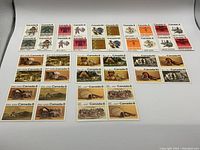 Photo showing 34 vintage Canadian stamps laid out in rows, mixed 8 and 10 cent denominations, depicting Indigenous themes and cultural images from 1972 and 1973.