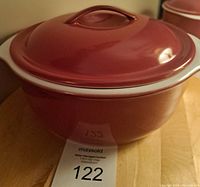 Large cranberry Corelle dish with lid shown from a top angle highlighting the lid design and shape.