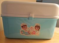 Plastic blue and pink medical toy storage box with sticker reading 'Cute Stone Doctor' featuring cartoon doctors