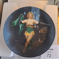 Front view of the collector's plate showing Marilyn Monroe in costume as Cherie in Bus Stop with a dark background.