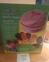 Box showing the Sesame Street branding and waffle maker design with images of heart-shaped waffles and the character on front.