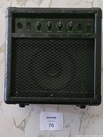 Front view of Vibe V-10G practice amplifier showing control panel with volume, bass, middle, treble, and phones jacks with overdrive knob.