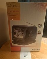 Photo of the Curtis 5 inch portable black and white TV box showing front with TV and radio image and product details.