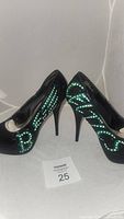 Front and side view of black Bamboo high-heeled dress shoes with green and white Celtics themed custom paint and rhinestones.