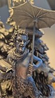 Close-up of the detailed Mr. Tumnus figurine holding an umbrella and books.