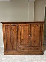 Front view of the Habersham Plantation wooden cabinet showing the three doors and single drawer base