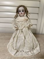 Front view full doll showing dress and stand
