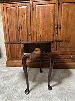 Front view of the vintage Ethan Allen Georgian Court cherry wood drop leaf end table with Queen Anne style cabriole legs.