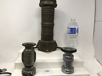 Wide shot showing all three firehose ends and a water bottle for scale