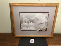 Full view of framed artwork showing lynx relief and matting
