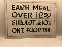 Front of the cardboard sign showing text and condition.