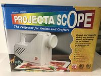 Front box image showing model PI768 Projecta Scope projector for artists and crafters, highlighting usage for projecting and magnifying various art and craft images up to 5 times.