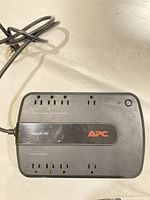 Top view of APC BE550G UPS showing 8 outlets and power button.